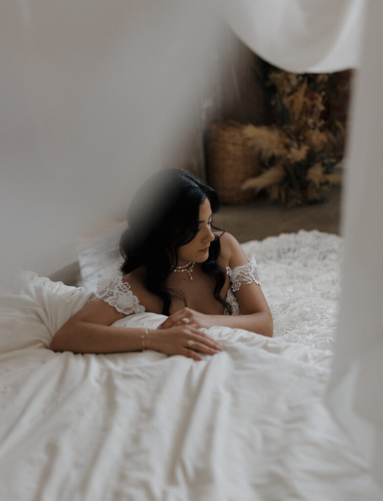 Dallas bridal portraits with bride in lace wedding dress standing in natural light, editorial style