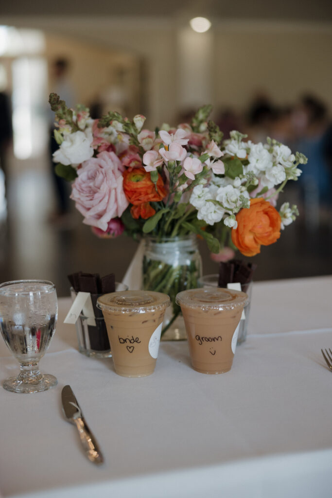 Intimate wedding dinner setup with floral centerpieces and custom chocolate favors.